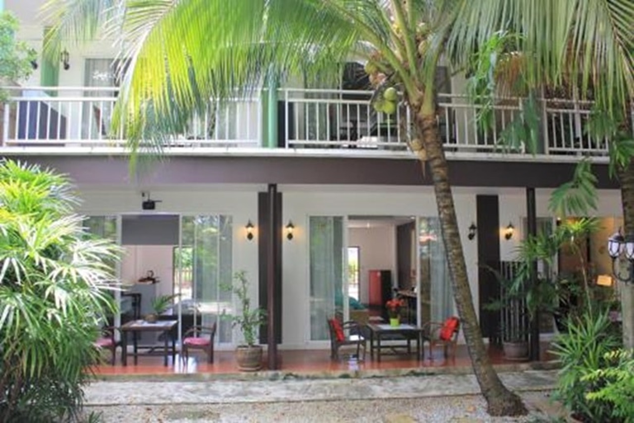 Exterior view of the Eat N Sleep Phuket Hotel with balconies and quiet road holding.